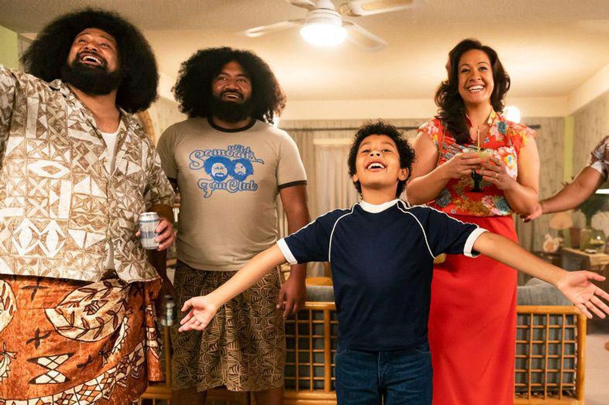 Fictional young Dwayne Johnshon and his family laughing and smiling in a scene from Young Rock