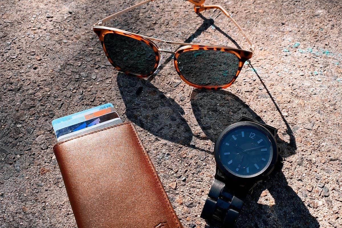 An Ekster Parliament Wallet, sunglasses, and a watch