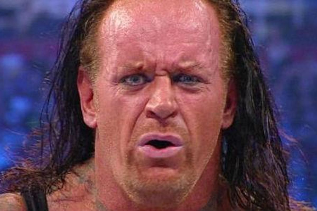 A close up of The Undertaker's face with a perplexed look