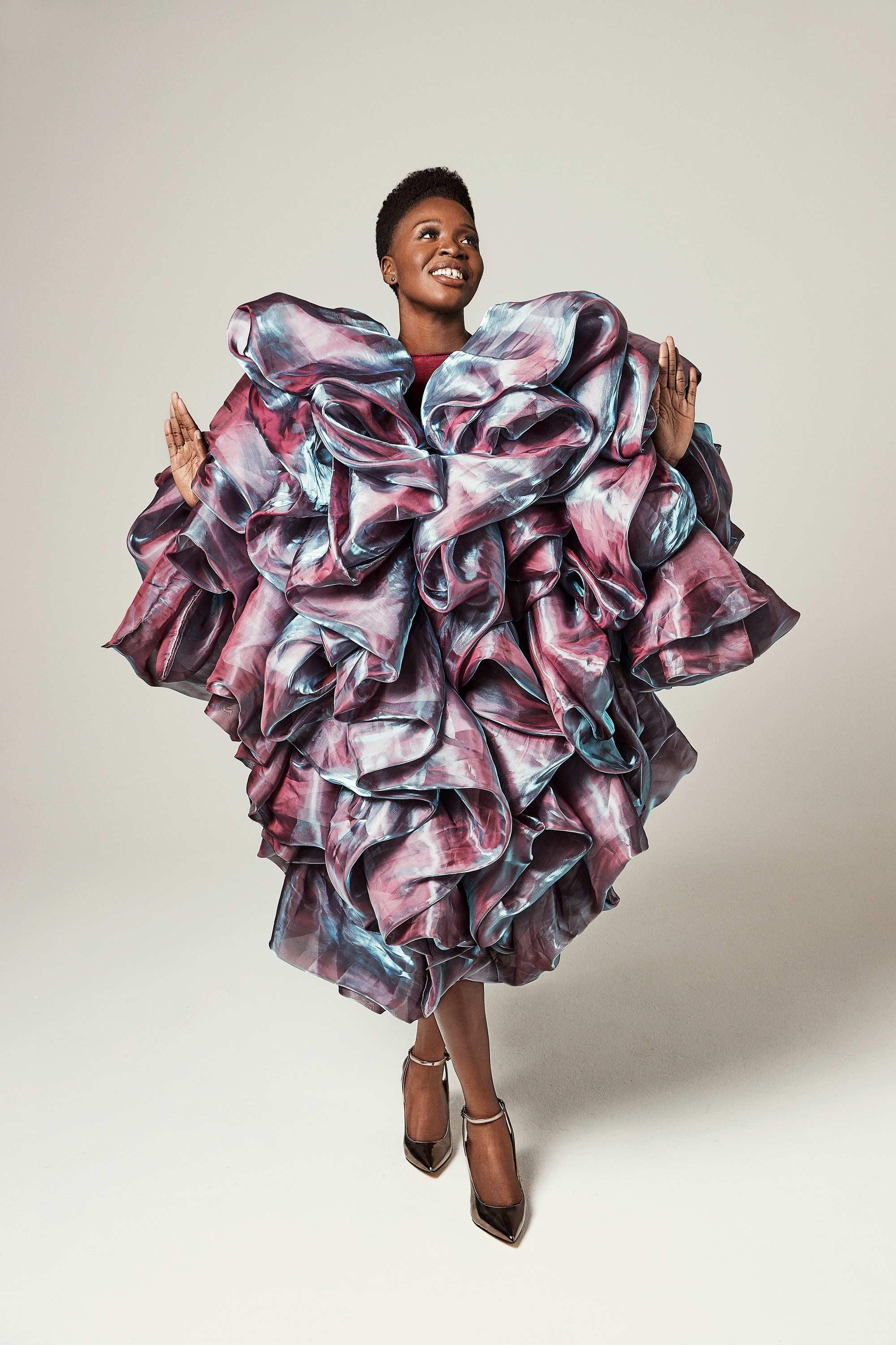 Folake Olowofoyeku in a lavishly ruffled iridescent dress