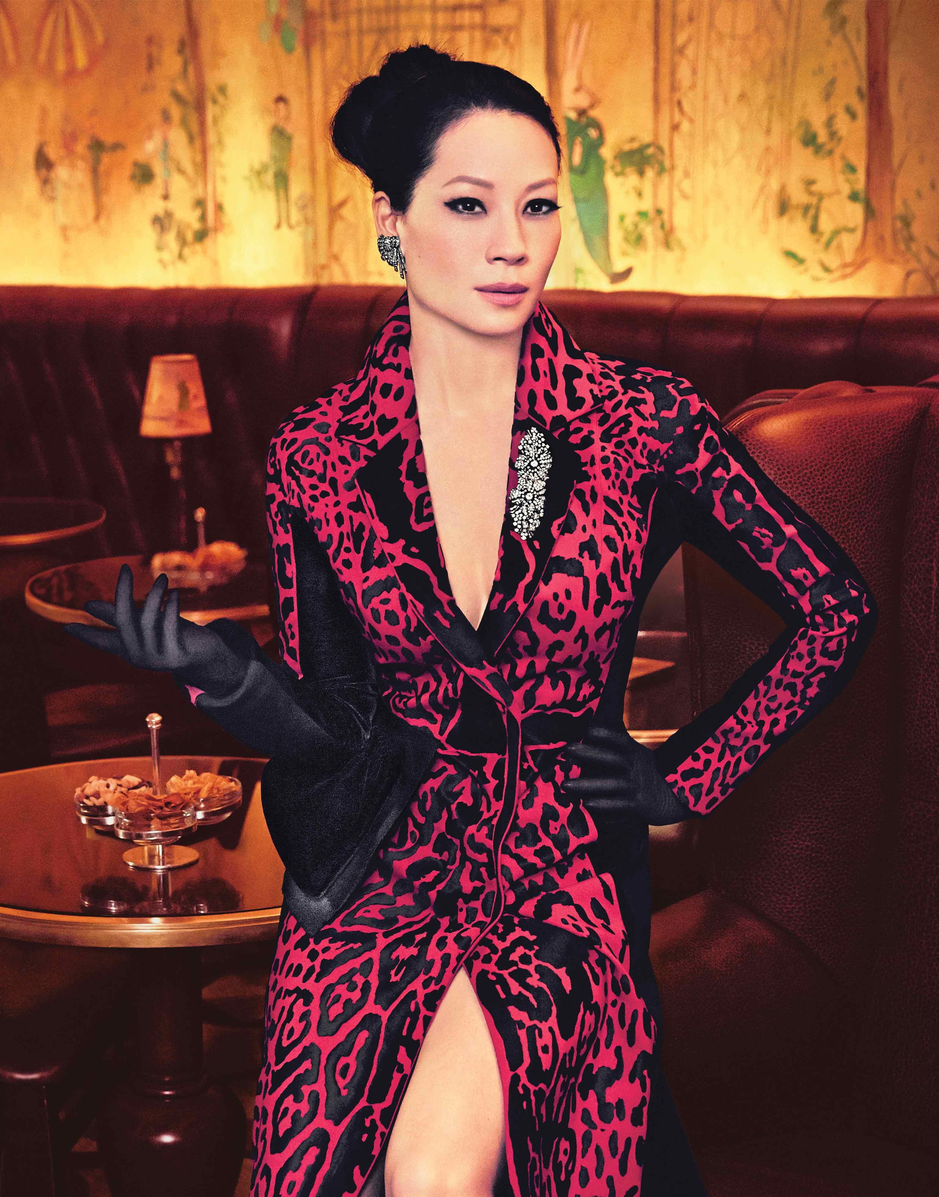 Lucy Liu channels film noir glamour in a red and black dress with a plunging neckline