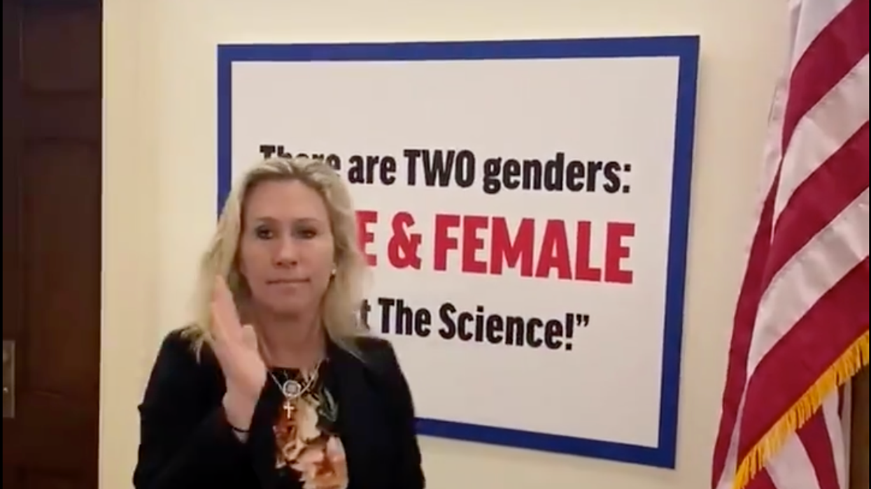 Rep. Marjorie Taylor Greene (R-Ga) puts up transphobic sign outside of her office.