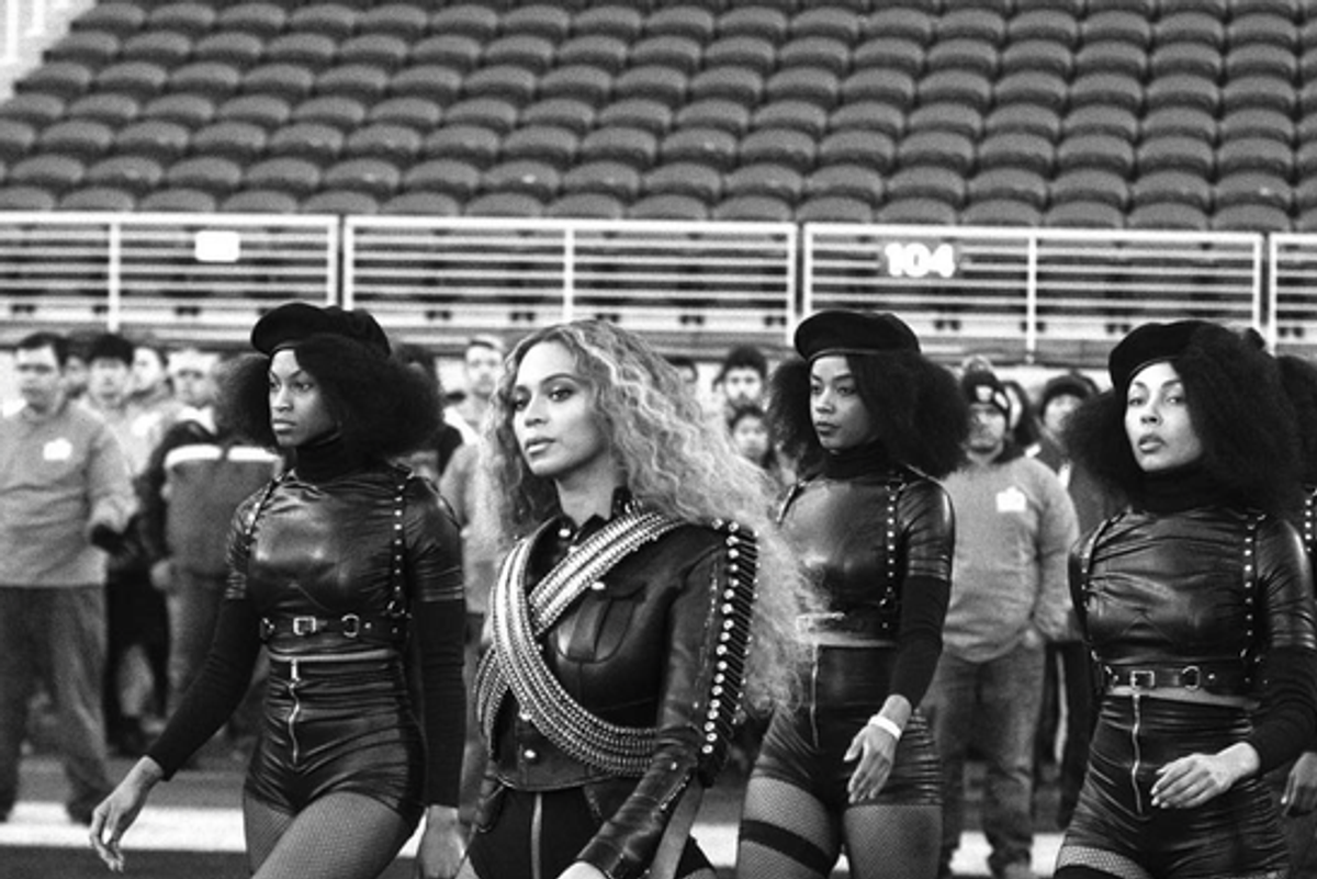 Beyonce with her back up dancers in Black Panther-like berets at Super Bowl 50 in 2016