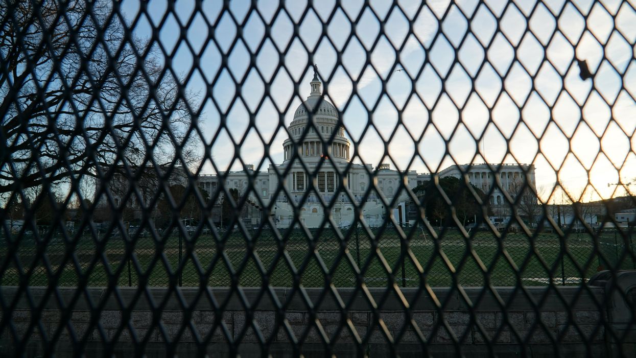 U.S. Capitol building from behind a fence 