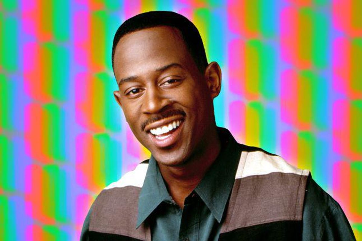 Martin Lawrence smiling in front of colorful background