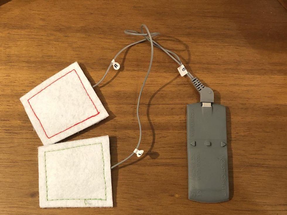 A photo of speakers connected to power bank on a table top