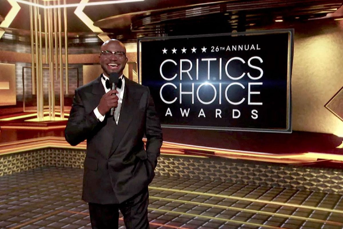 Taye Diggs with the Critics Choice Logo behind him