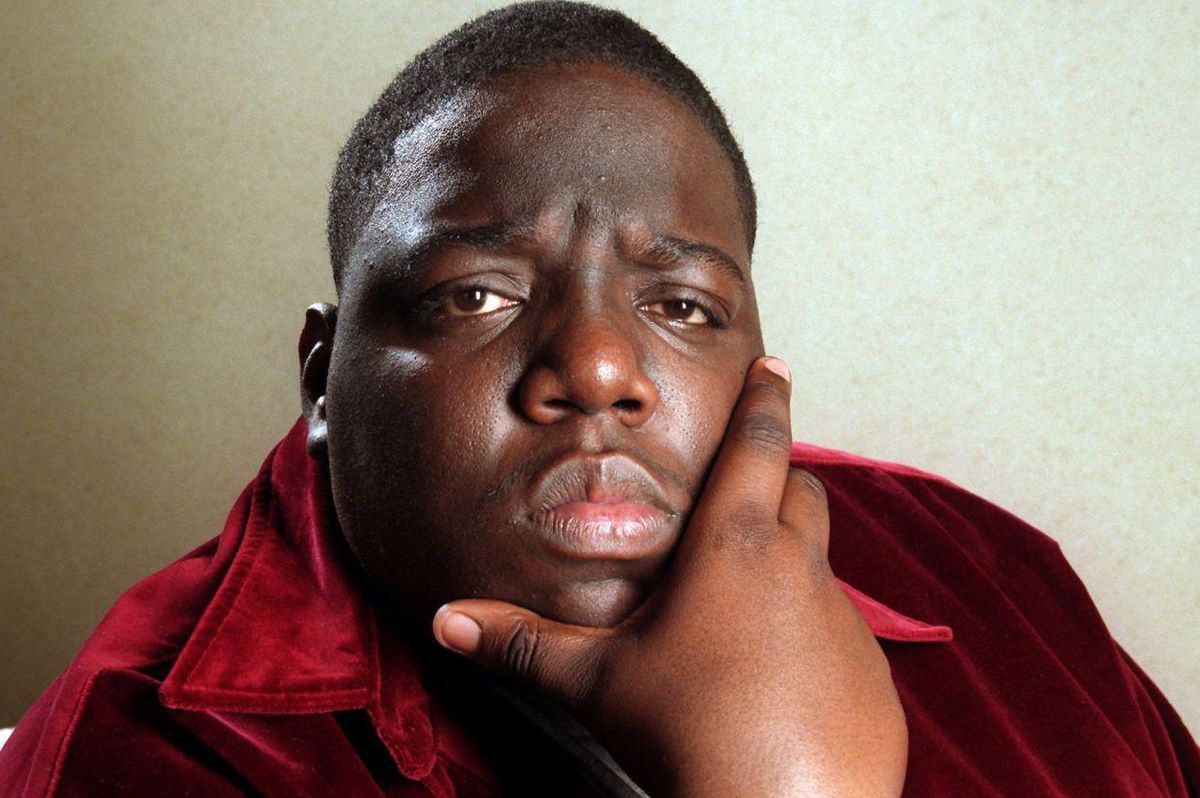 The Notorious B.I.G. posing with his hand on his chin
