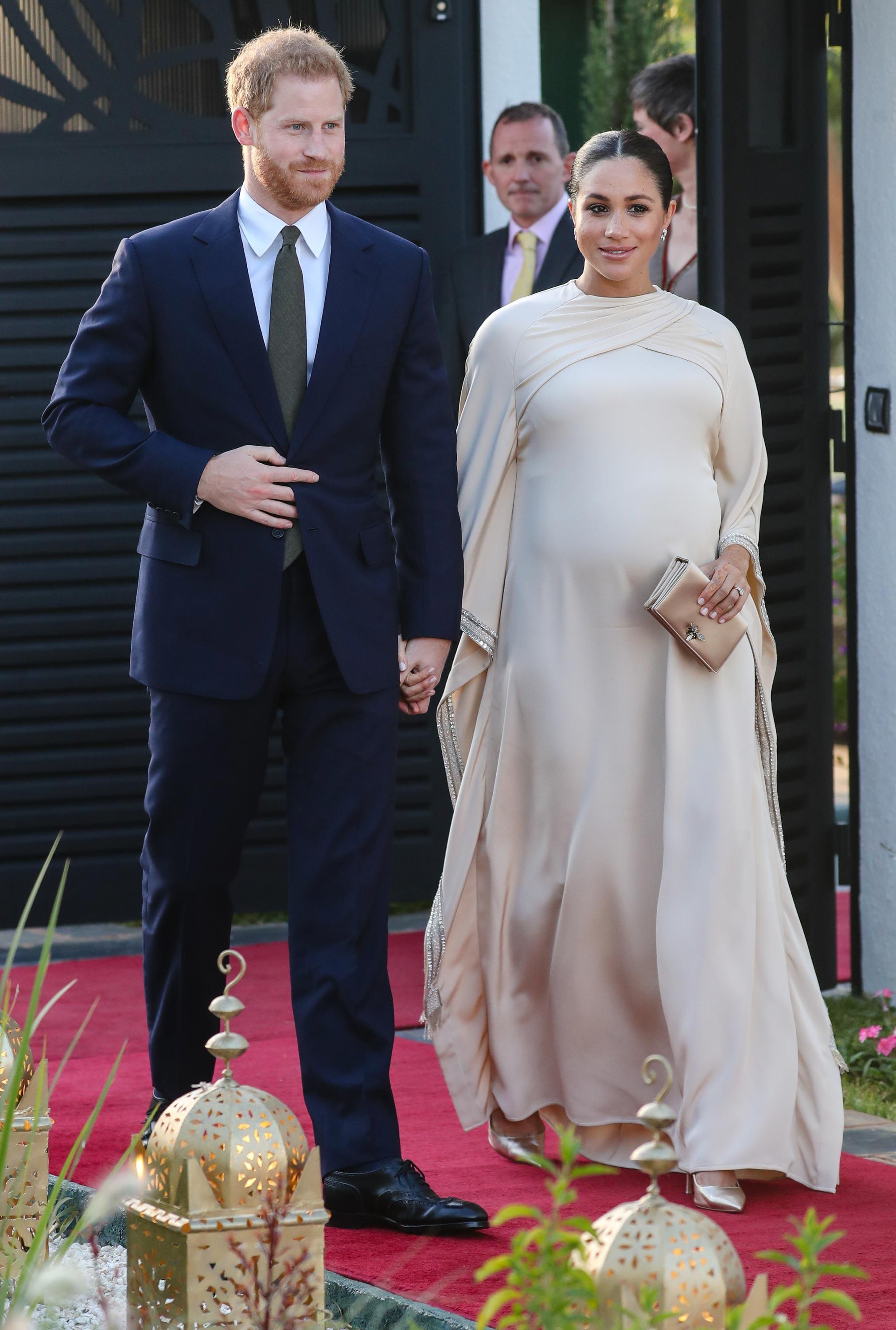 Meghan sports a very visible baby bump while walking the red carpet with Harry in Morocco