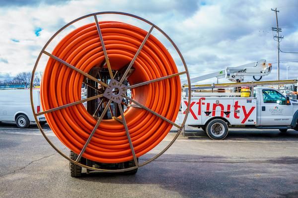 photo of Comcast workers installing fiber network.