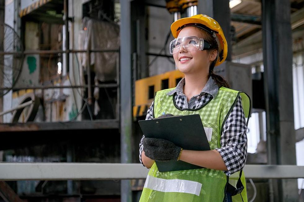 Woman follows workplace safety guidelines