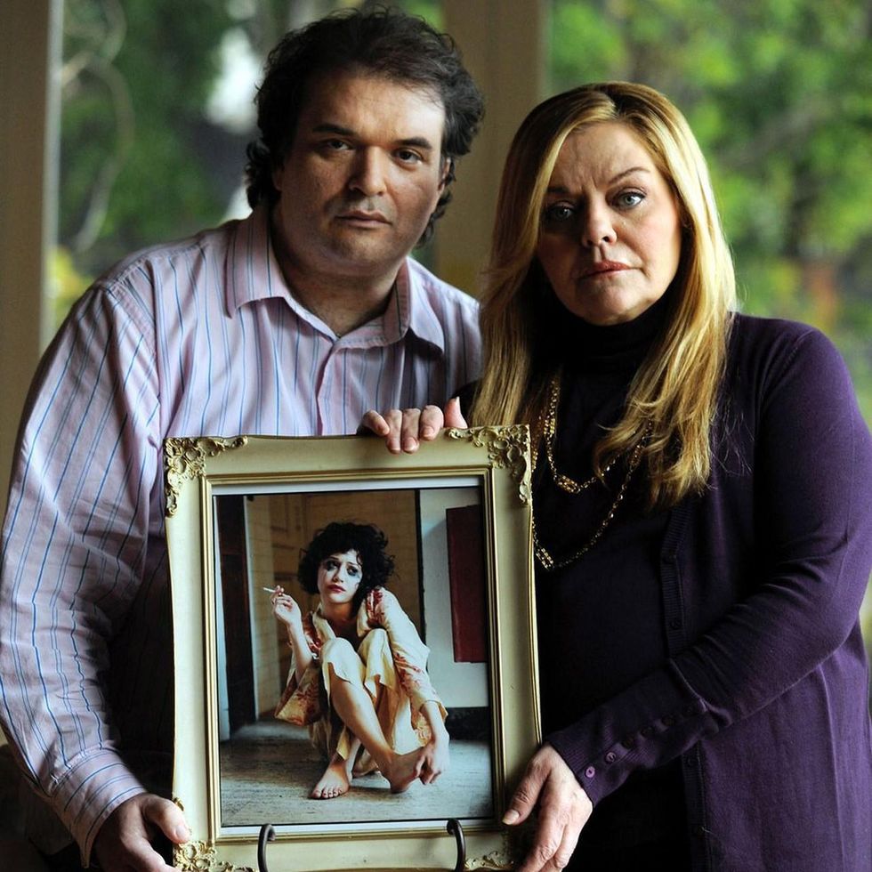 Simon Monjack and Sharon Murphy holding an image of Brittany Murphy after her death