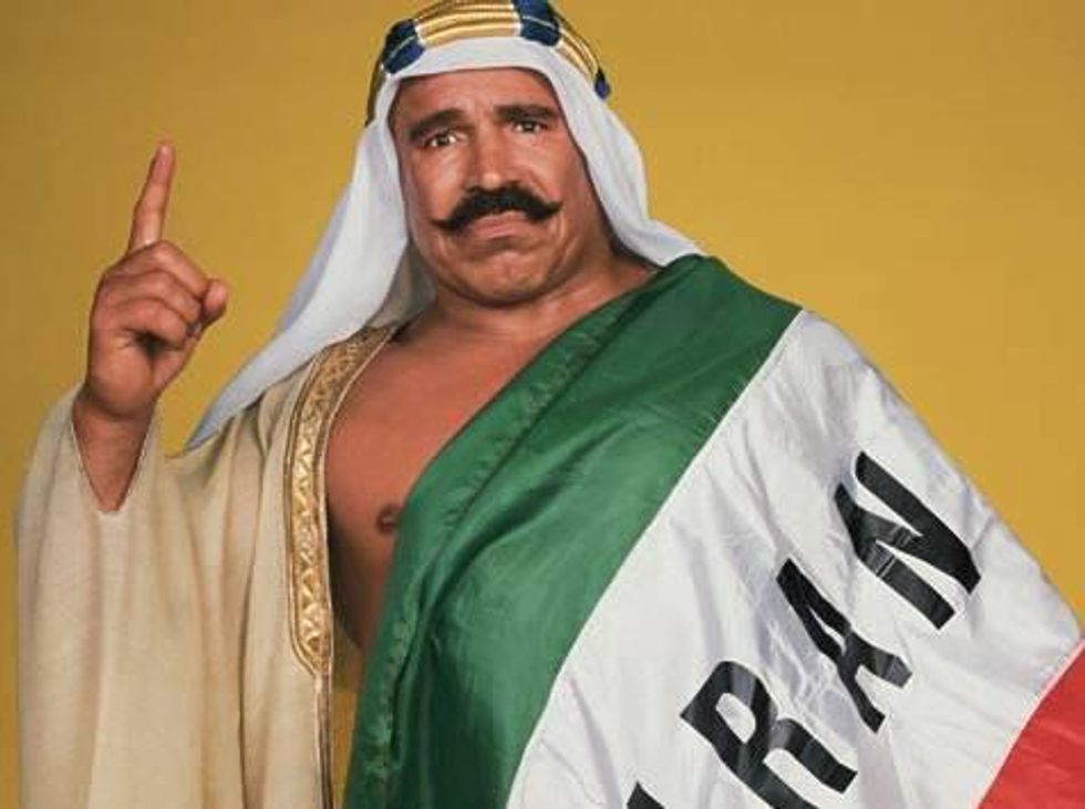 \u200bThe Iron Sheik wrapped in an Iranian flag holding up the number one