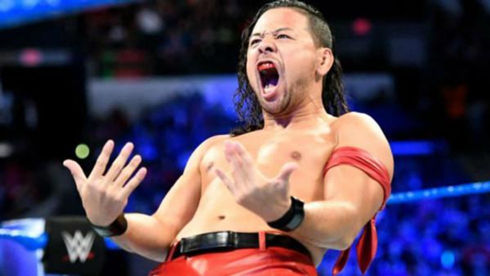 Shinsuke Nakamura motiong his opponet to charge at him