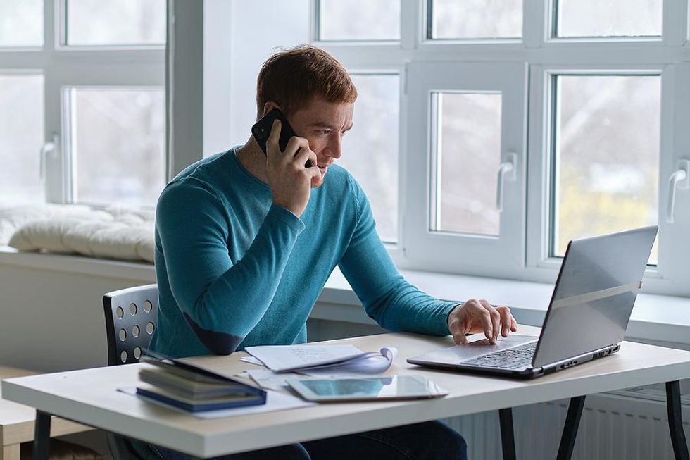 A job seekers works on his resume and cover letter.