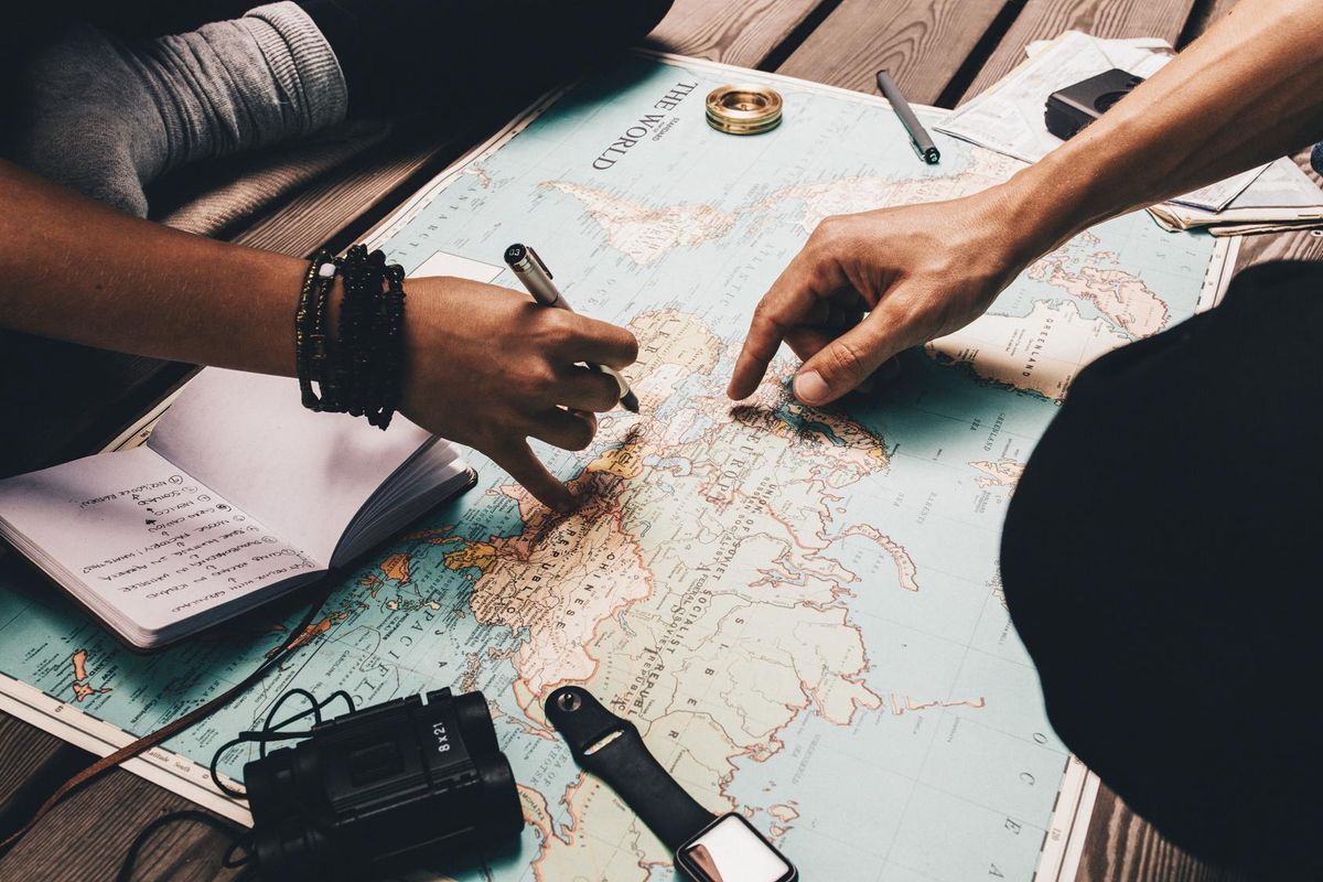 People planning a trip using a map