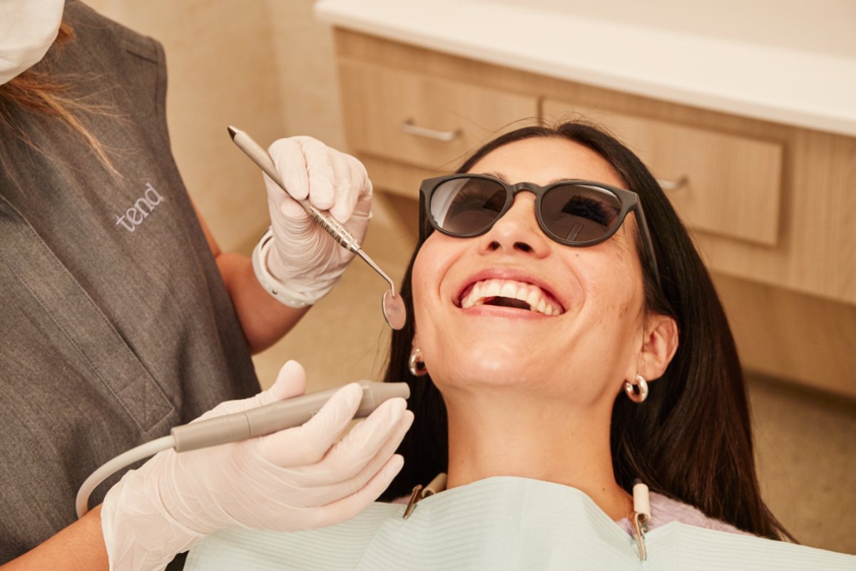 woman in dentist chair with dentist beside her 