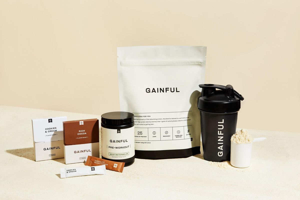 gainful protein bag with gainful preworkout mix and shaker with cream background 