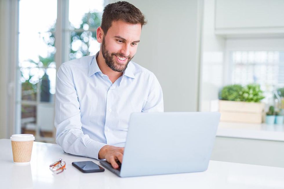 Man sends an email while working from home