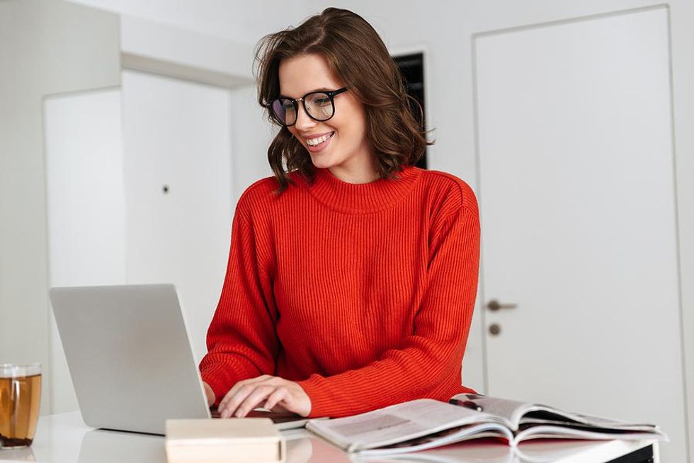 Woman smiles while she works remotely