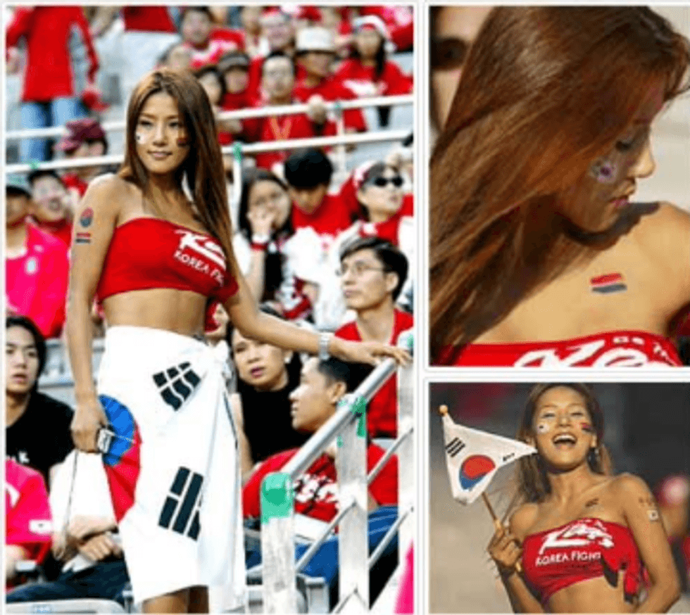 A young Korean woman wearing a red cut off shirt like a bikini top, and a Korean flag around her waist like a skirt