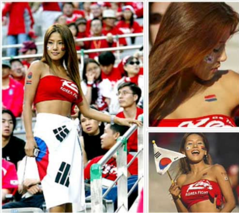 A young Korean woman wearing a red cut off shirt like a bikini top, and a Korean flag around her waist like a skirt