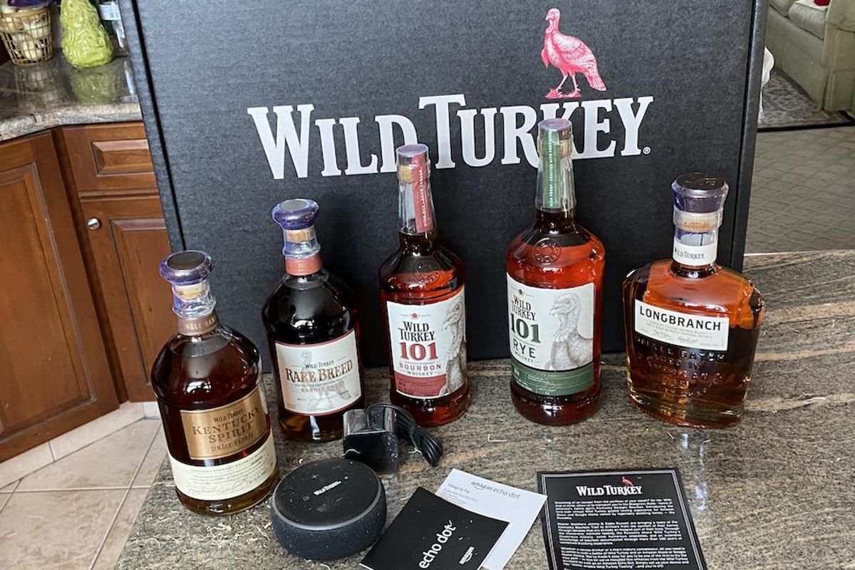 Wild Turkey bottles on a counter with Amazon Echo Dot and instructions
