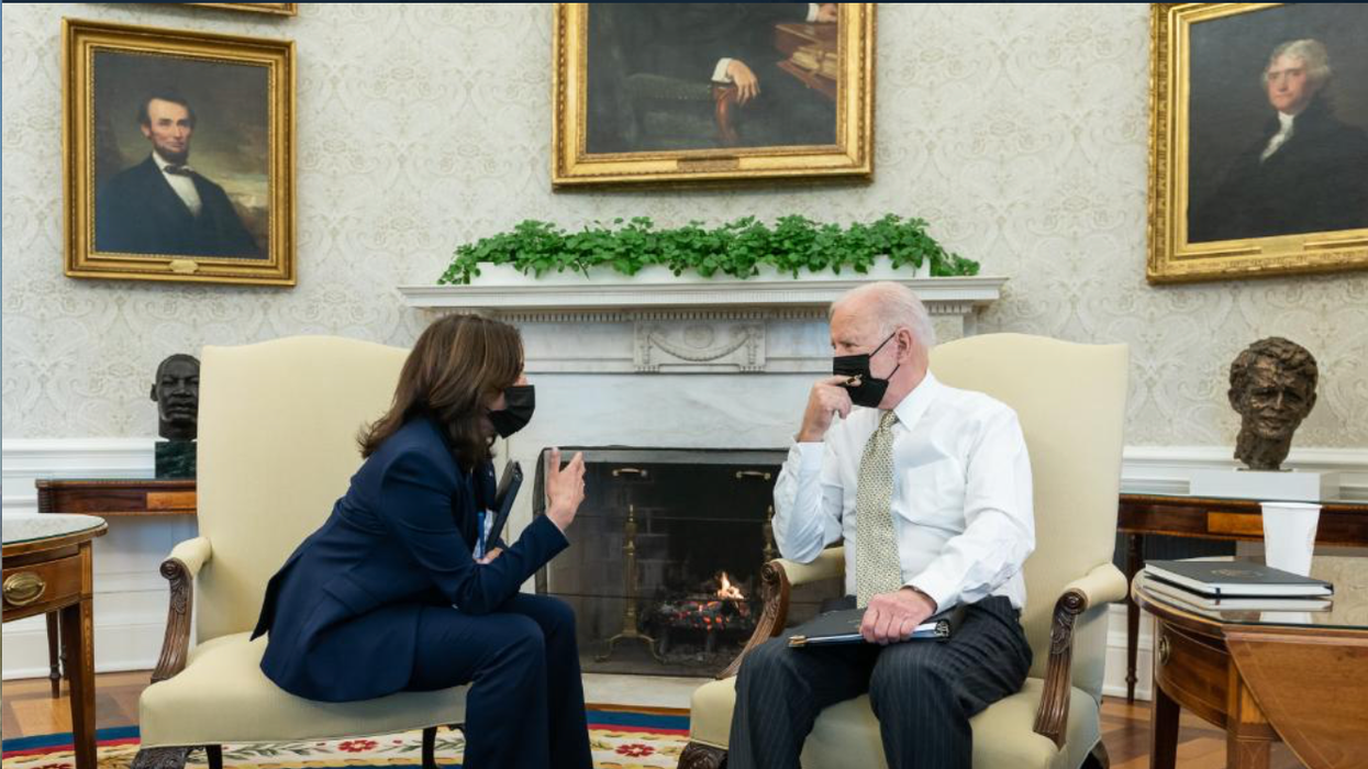 President Biden and Vice President Harris having a discussion in the Oval Office.