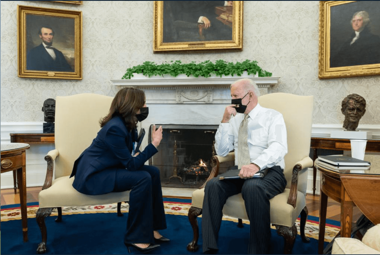 President Biden and Vice President Harris having a discussion in the Oval Office. 