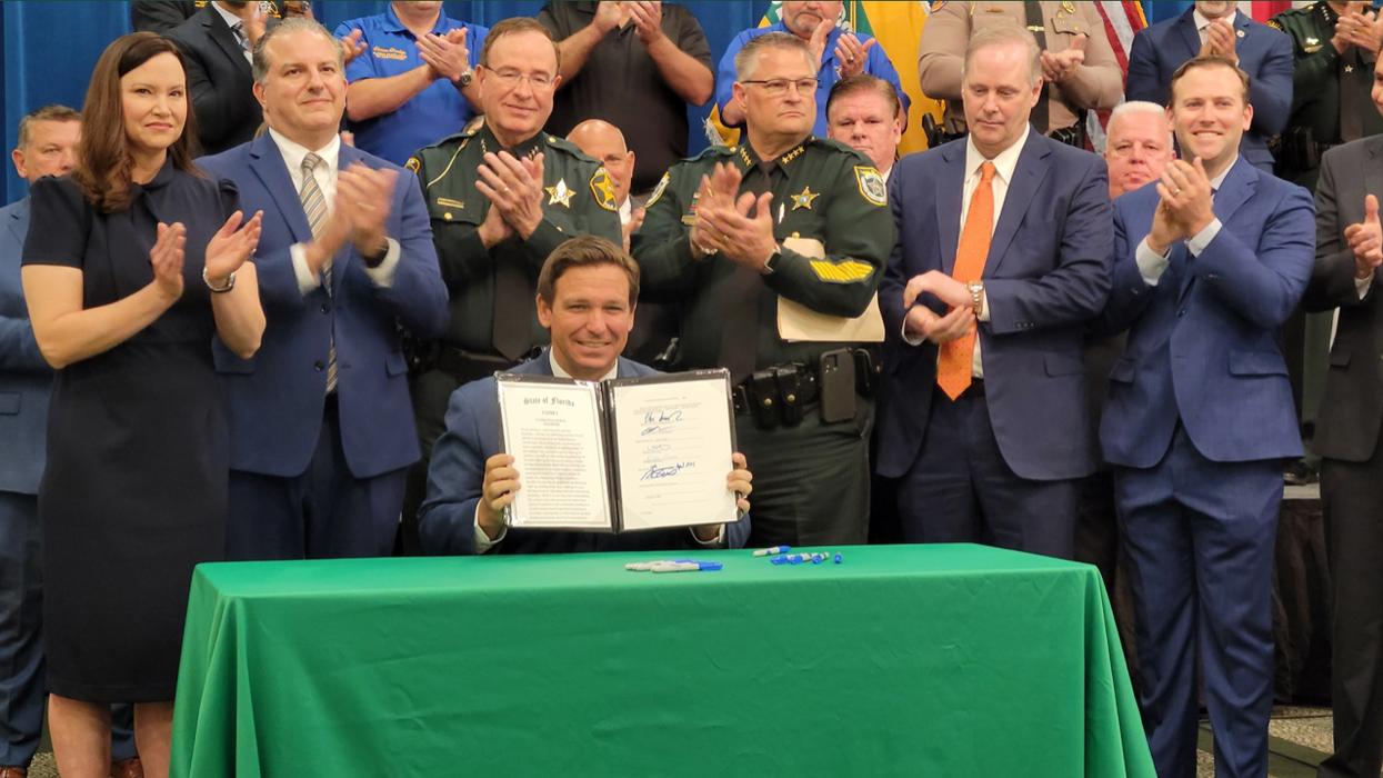 Florida Gov. Ron DeSantis celebrating the passage of "Jim Crow" bill HB 1.