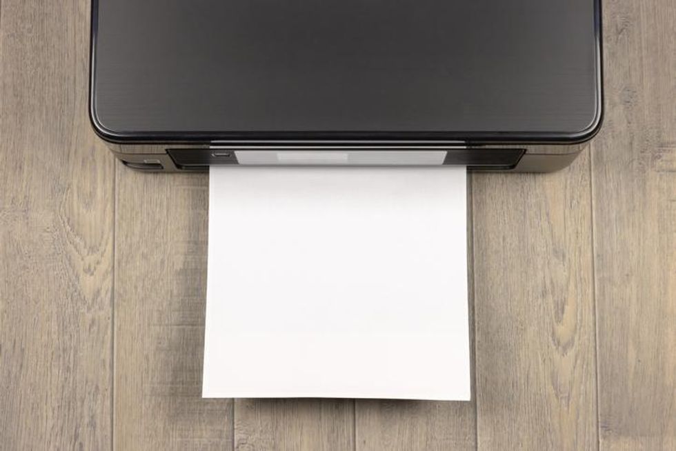 A printer with a sheet of paper