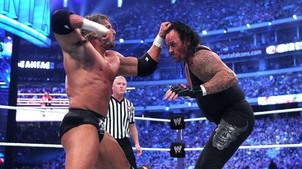 Thriple H punching The Undertaker