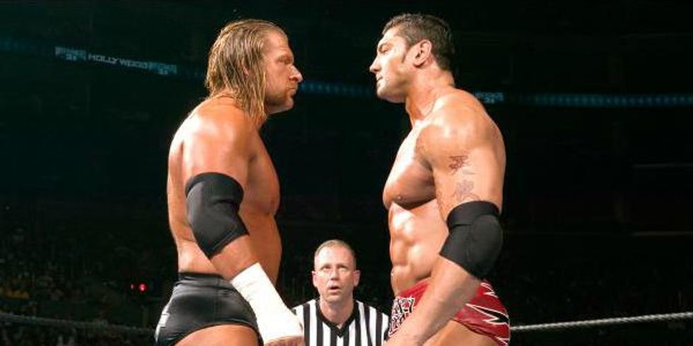 Triple H and Batista standing face to face