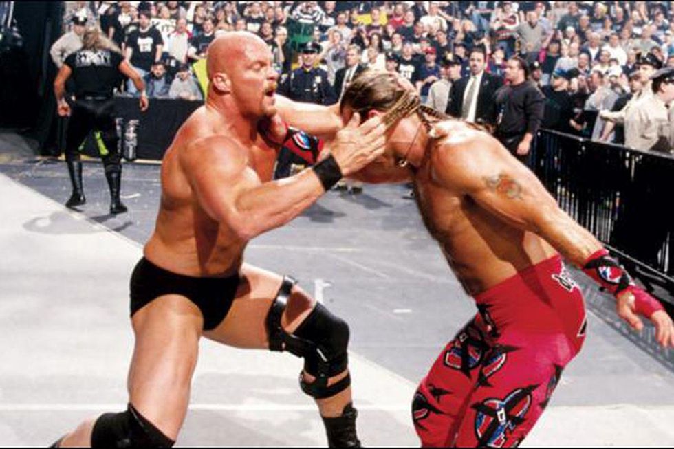 Stone Cold and Shawn Michaels fighting outside of the ring