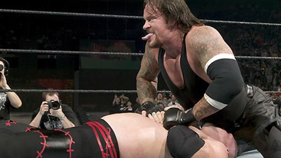 The Undertaker pinning Kane and sticking his tongue out