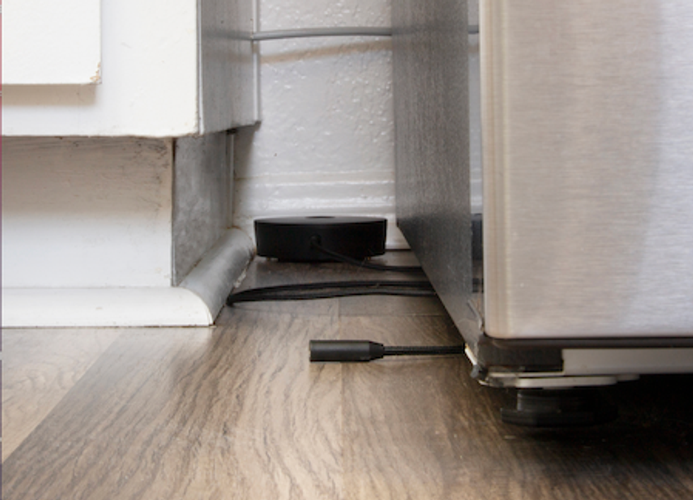 Phyn Water Sensor Cable underneath a refrigerator