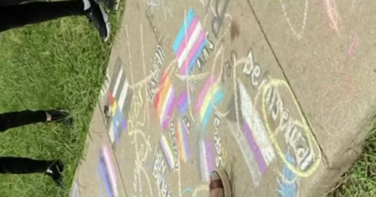 Students Outraged After Teacher Is Filmed Scrawling 'Heteros Rule' Over Their LGBTQ+ Pride Chalk Art