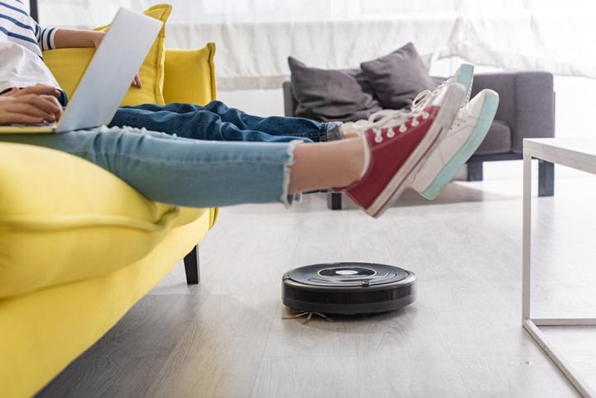 A robot vacuum sweeping under a couch