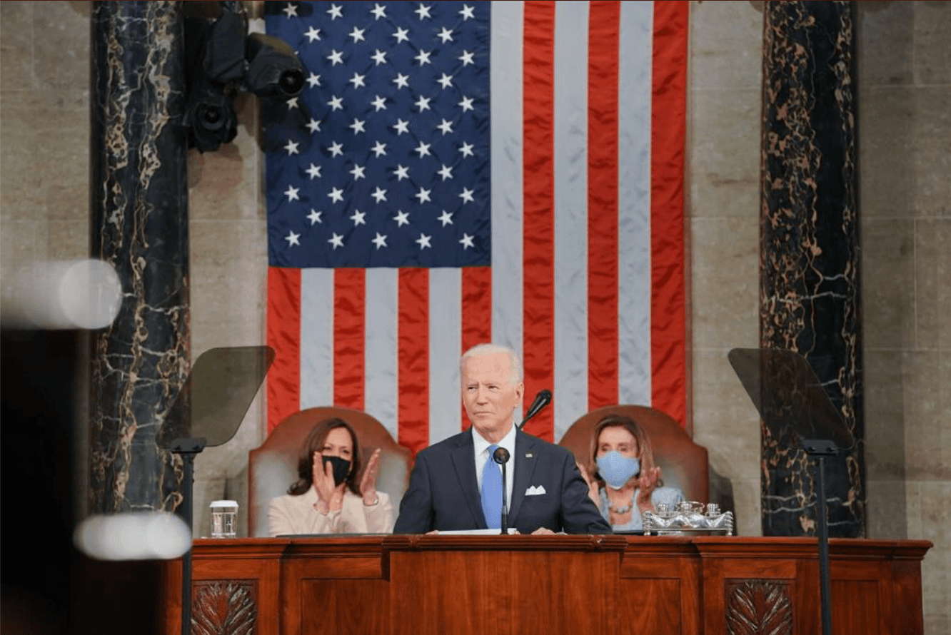 President Biden speaking at his first Congressional address in front of Vice President Harris, left, and House Speaker Pelosi. 