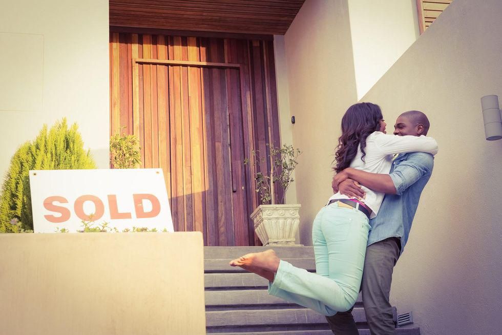 couple outside their home that has just been sold