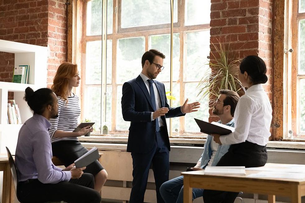 Leader holds a meeting with his team