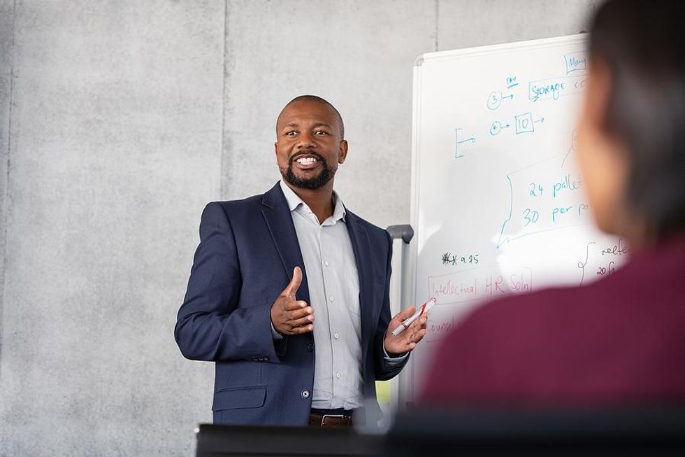 Man leads a meeting at work