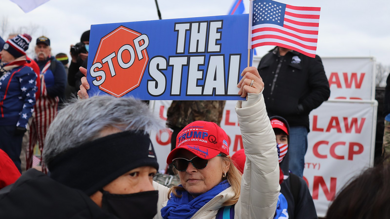 Trump-supporter holds "Stop the Steal" sign on the morning of the January 6, 2021 Capitol riot.