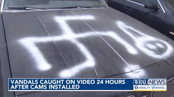 Auto shop vandalized with racist graffiti, so the owner installed cameras. Video captured two black suspects.