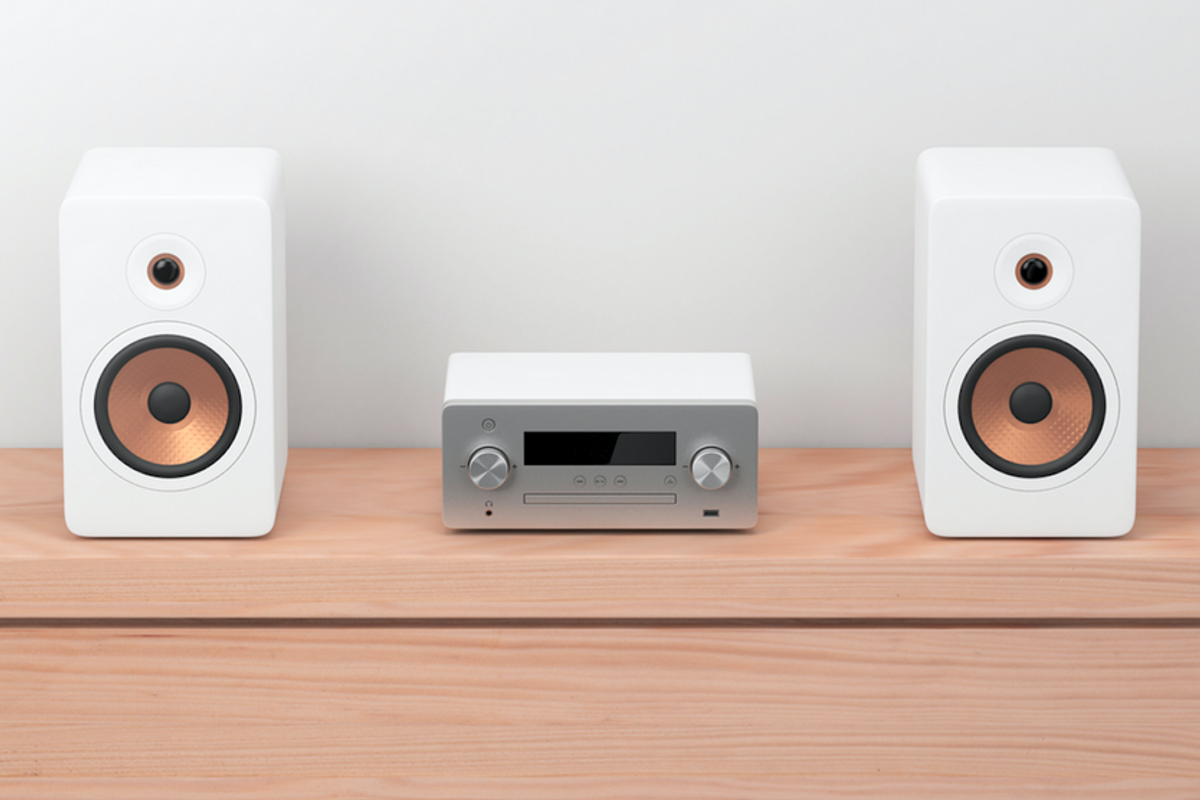 Two speakers next to a tuner