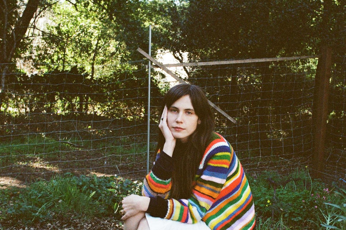 Los Angeles singer-songwriter Marina Allen sits in a garden.