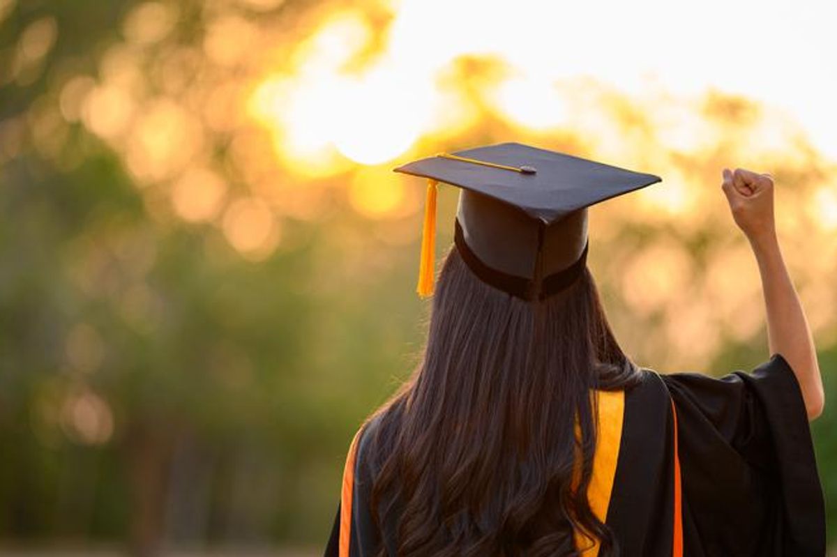 A new graduate wearing a cap and gown