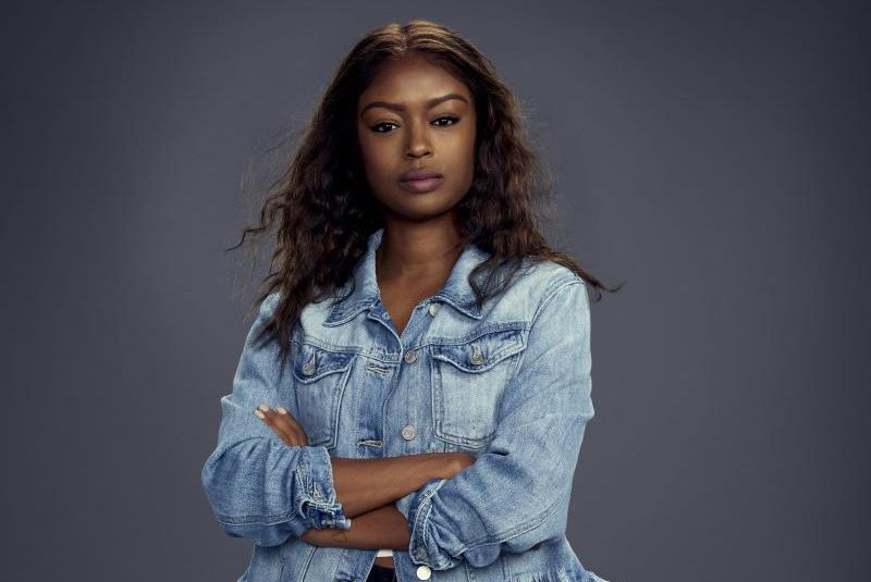 Javicia Leslie in jean jacket crossing her arms