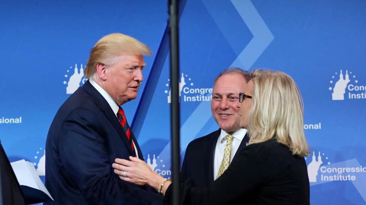 Rep. Liz Cheney, right, shaking hands with former President Trump.