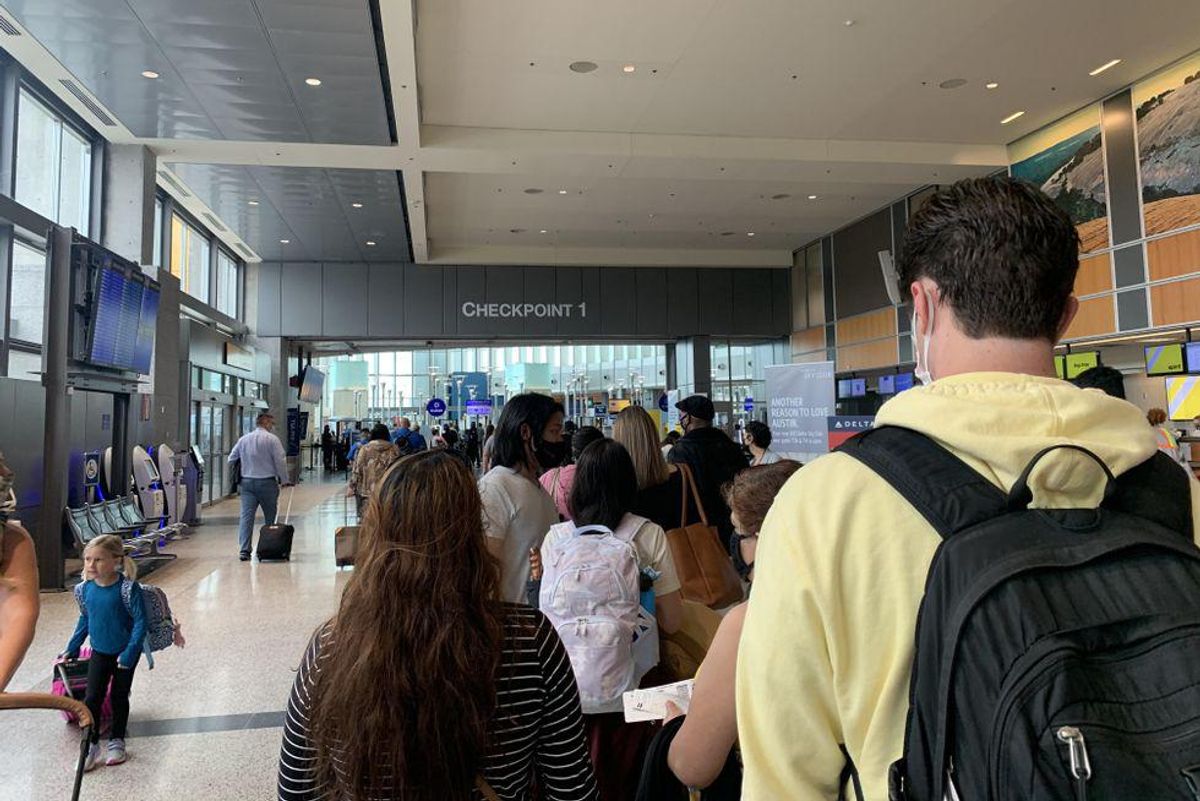Lines stretch across airport after bomb threat in what might be the busiest travel day since the pandemic